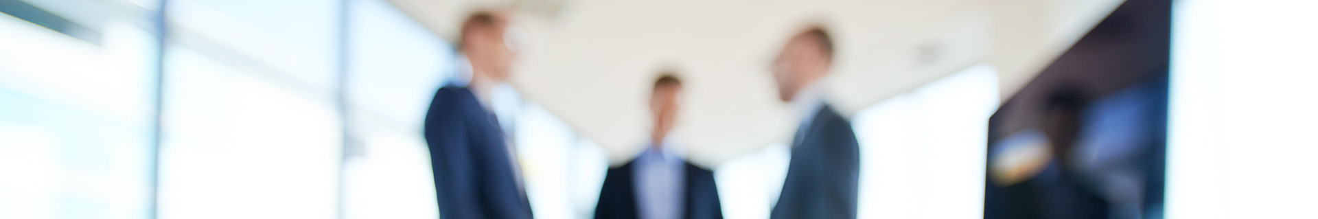 Orders and billing header image Blurred image of 3 businessmen discussing orders